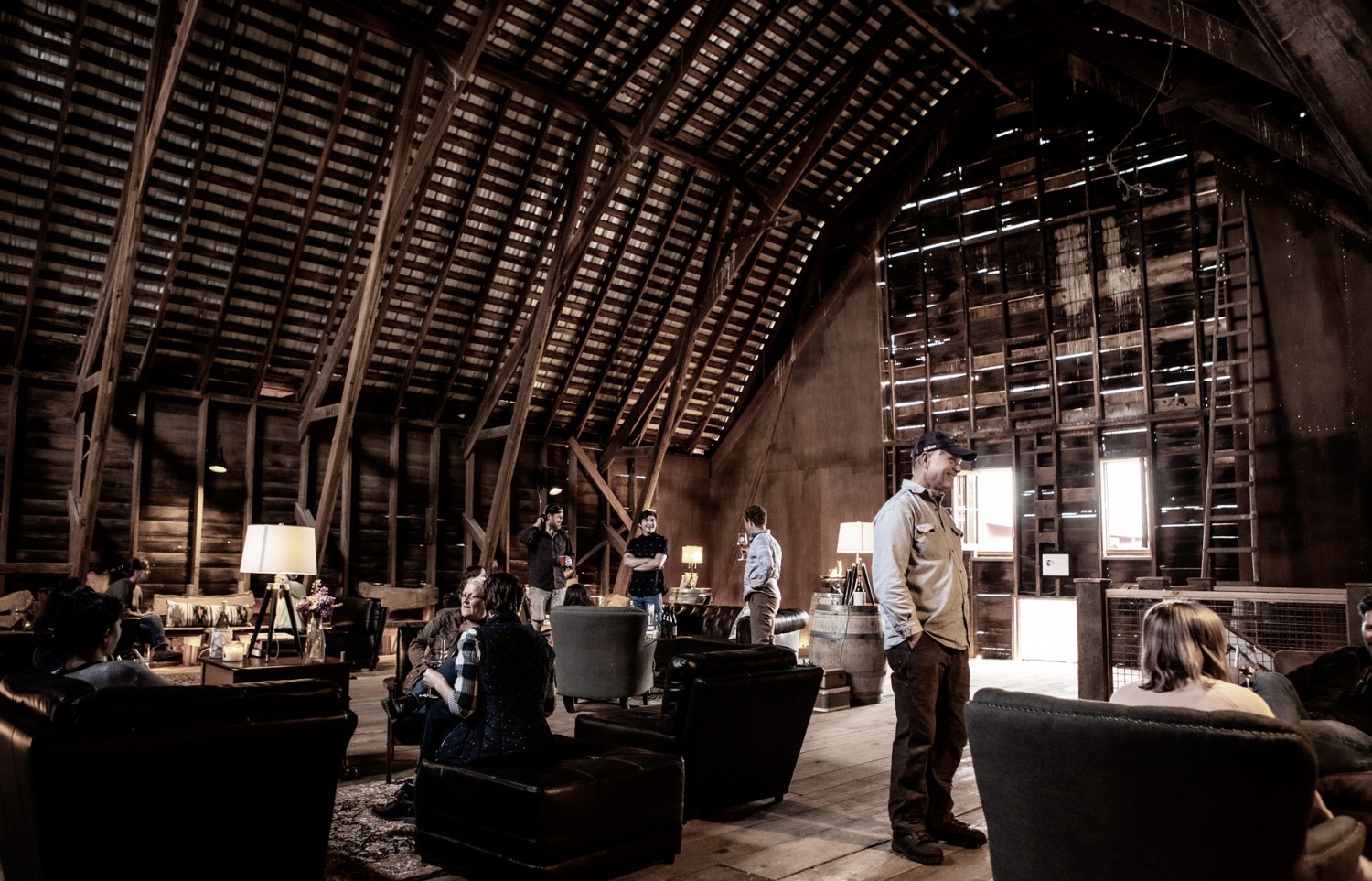 people enjoying a tasting in the upstairs of the barn